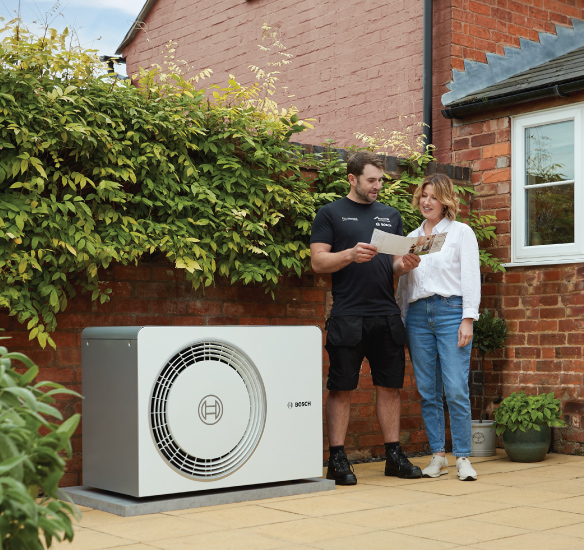 Installer outside with homeowner and heat pump